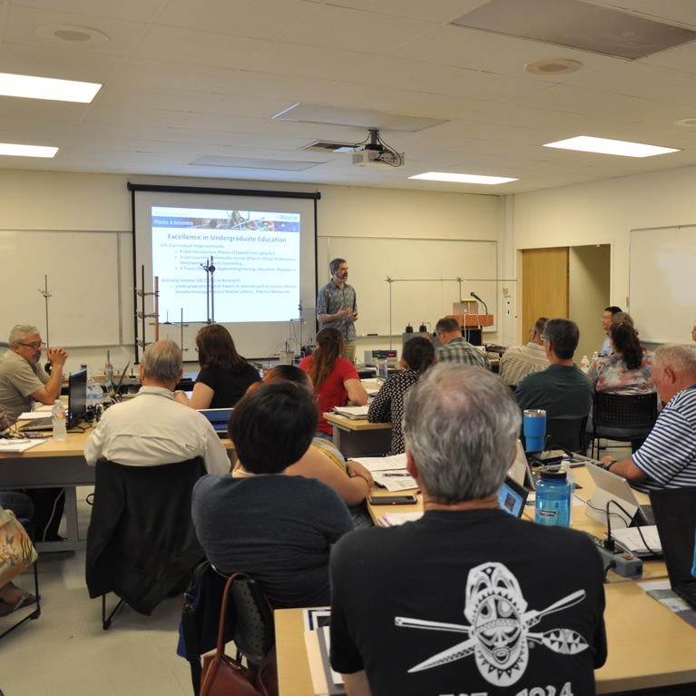 Kenneth Barish (standing), the chair of the Department of Physics and Astronomy, welcomed the participants with opening remarks.