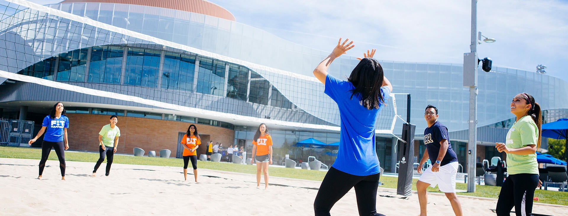Students playing volleyball at the Recreation center