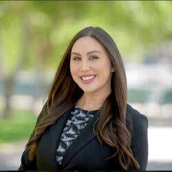 Elizabeth Jimenez, Manager of Transfer Success Programs, CNAS at UC Riverside, wearing a black and white design blouse with a black blazer, smiling for a headshot
