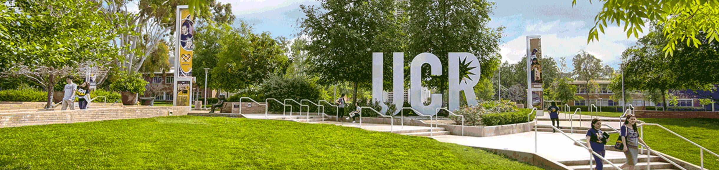 students walking past UCR sign (c) UCR/Stan Lim