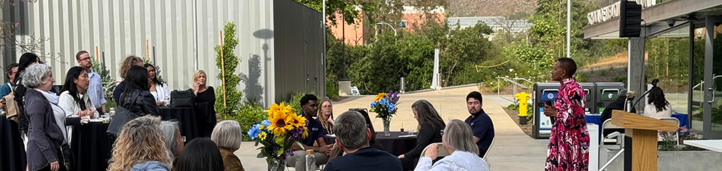 Dean Deas speaking at an event in the courtyard