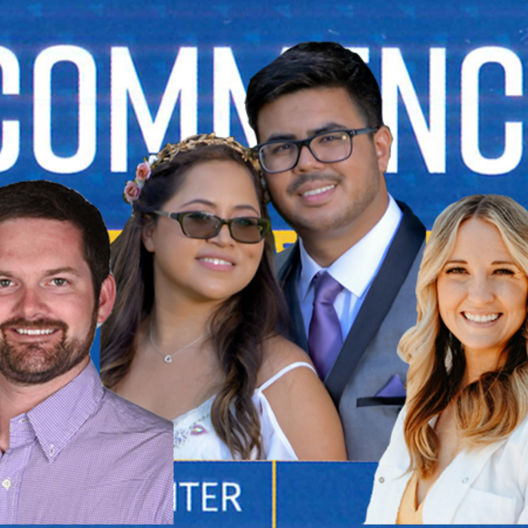 Biomed grads in front of a commencement sign