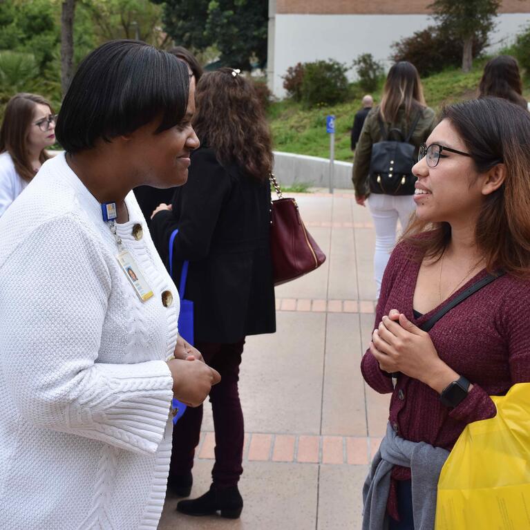 Teresa Cofield talking to a woman