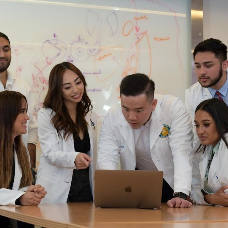 Students looking at a computer
