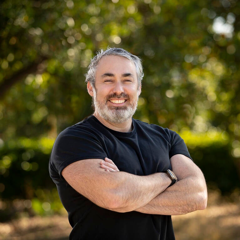 Brandon Brown in front of trees