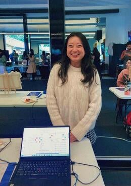Angelina Lam, class of 2025, with art project on laptop