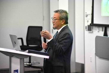 Dr. Lo standing at the podium presenting at the 2025 Haider Lecture