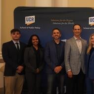 Group photo of debators, judges, and the dean