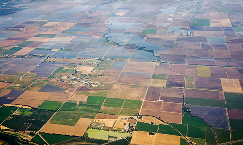 An aerial of farm land and housing