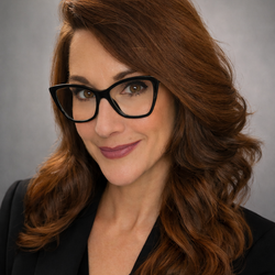 Kelli Breland, Talent Development Trainer, Human Resources at UC Merced, wearing a black shirt and blazer smiling for headshot