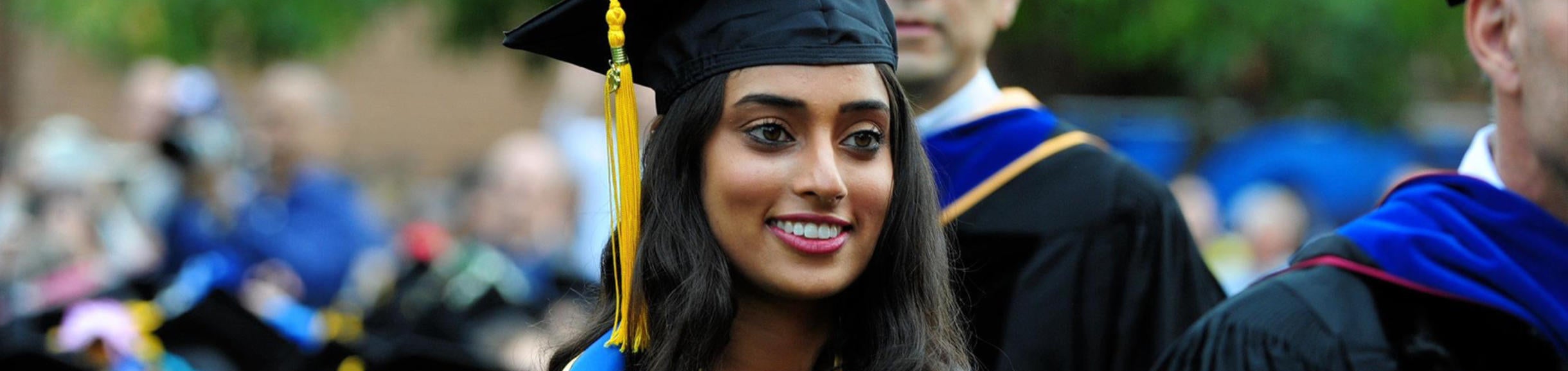 Graduate wearing cap and gown 