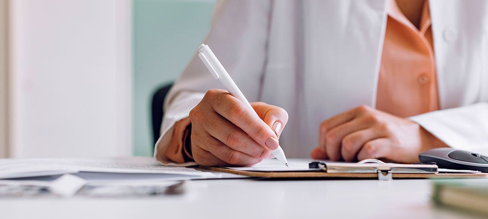 Doctor writes out a referral