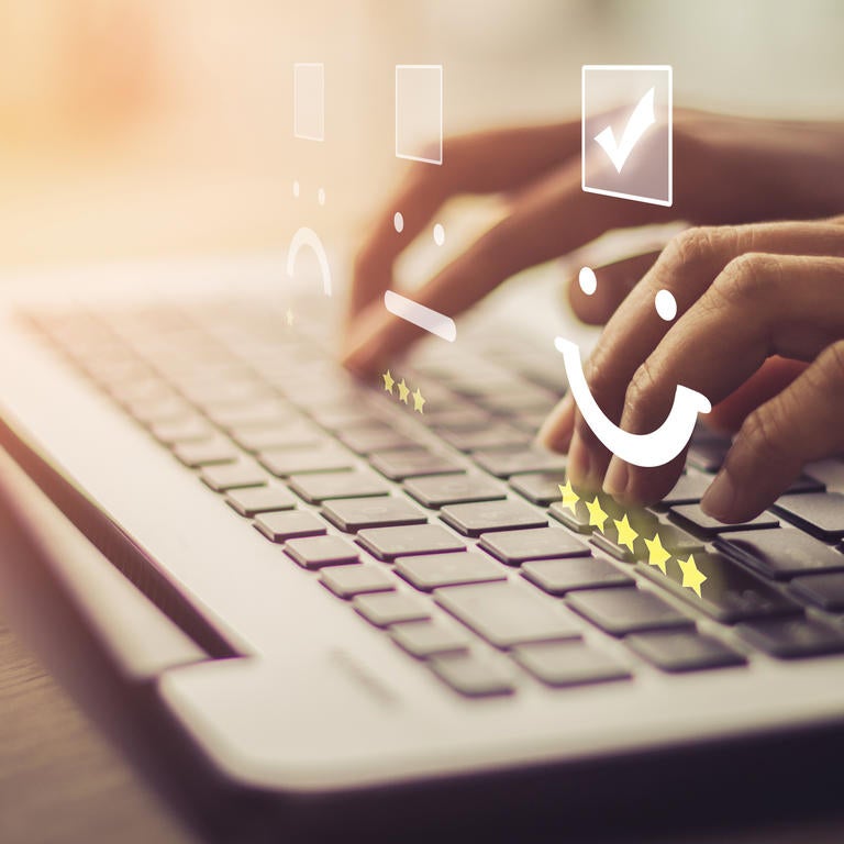 fingers typing on laptop keyboard