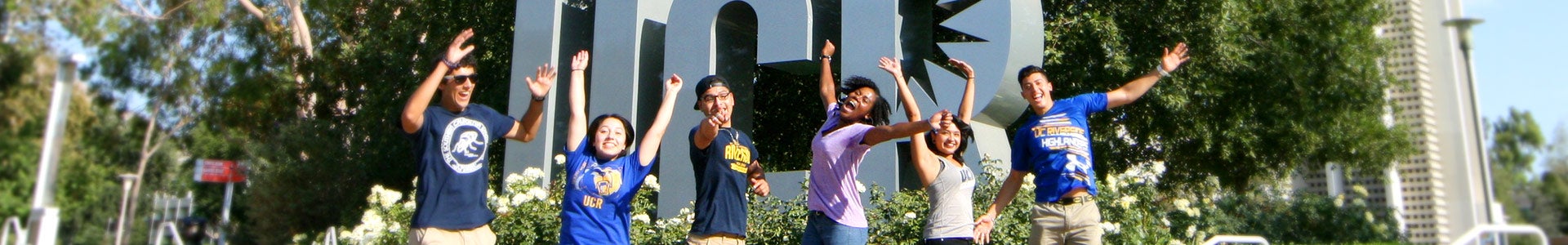 UCR students jumping and smiling