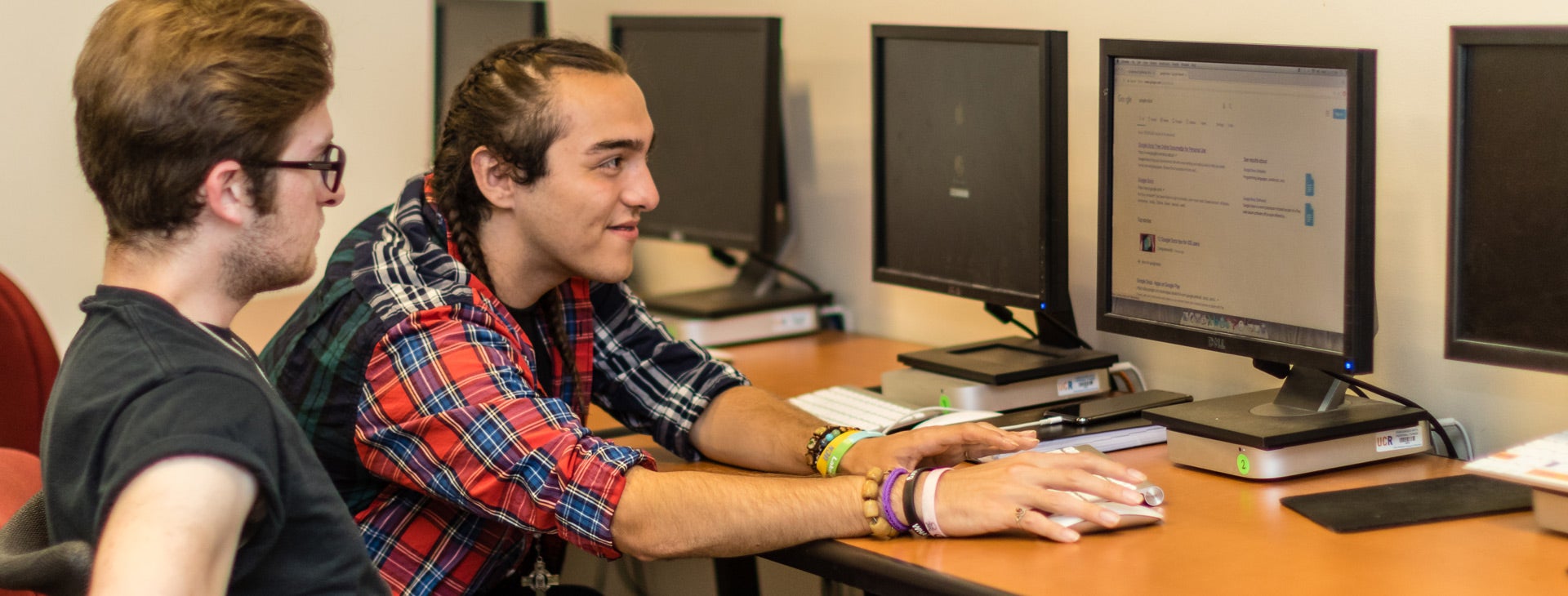 Two TRIO scholars students collaborating on a project at computer.