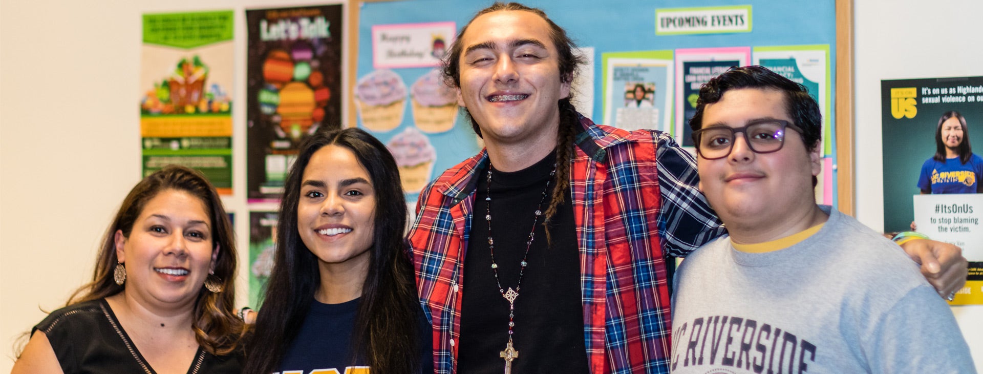 Four Trio Scholars students pose together inside the TRIO Scholars office.