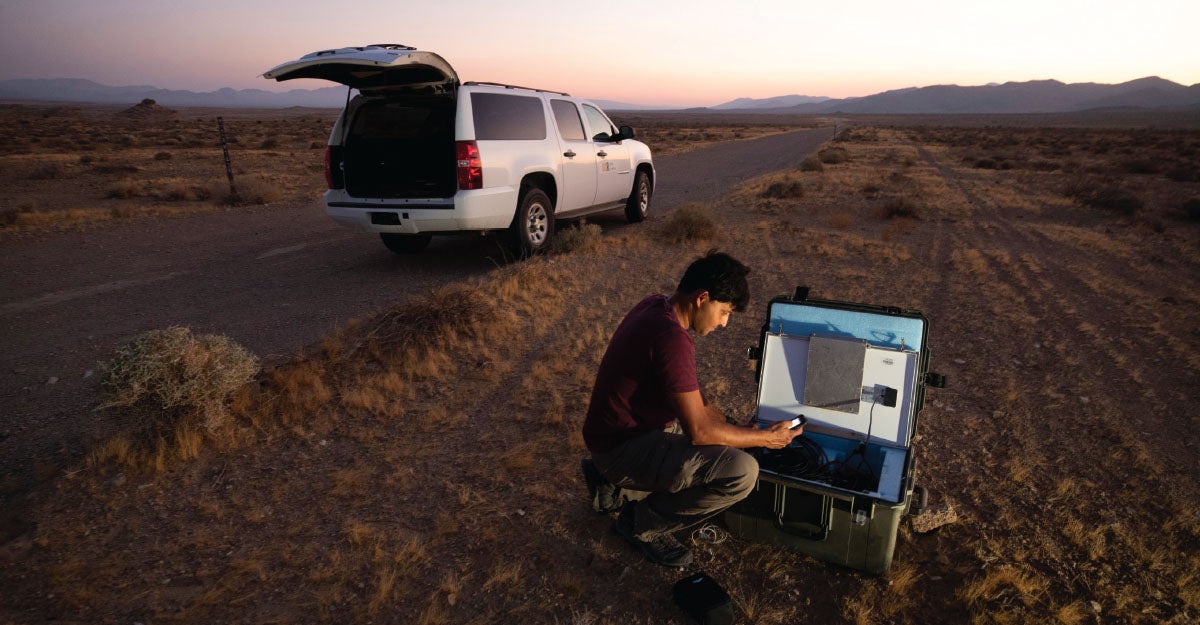 Photo of Ghosh checking equipment at the San Andreas Fault