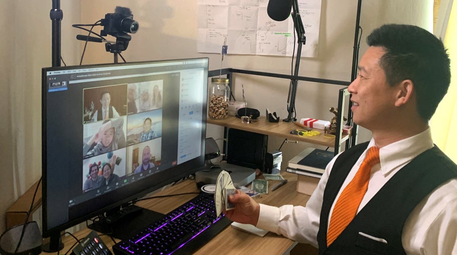 Dan Chan at his Fremont home performing magic for a Zoom audience.