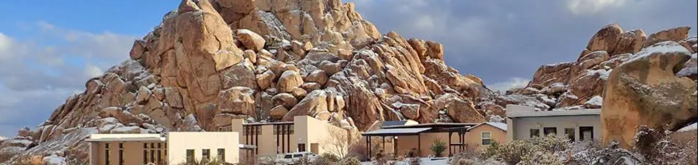 Field station buildings among rocks in snow