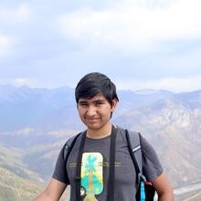Man standing in front of mountains