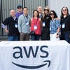 Group photo of AWS representatives at their sponsor booth.