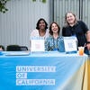 Attendees smiling at the UC Tech News booth.