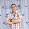 Attendee smiling in front of the UC Tech backdrop.