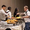 Attendees getting breakfast at the buffet.