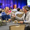 Attendees socializing with each other during breakfast.