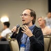 Attendee holding a microphone to ask questions.