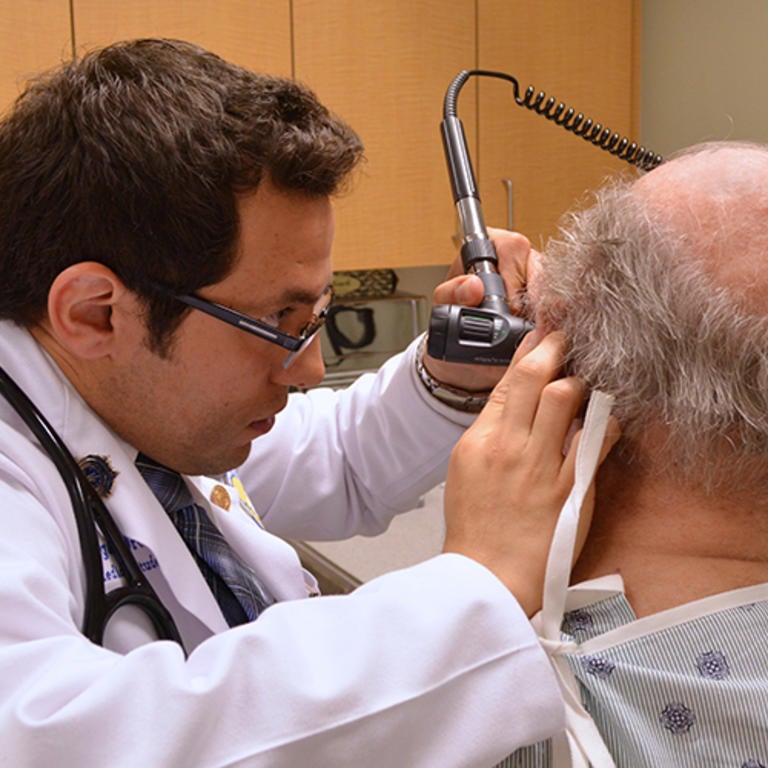 Student examining patient