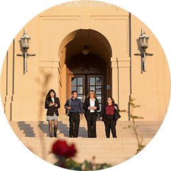 4 students walking down the stairs of Anderson Hall, UCR School of Business