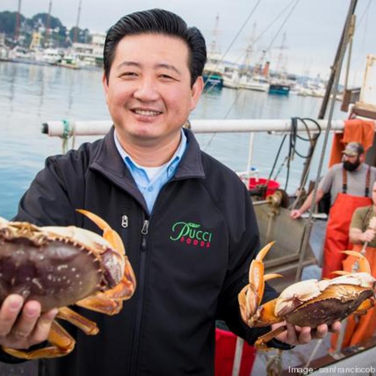 Chris Lam holding up a fresh crab
