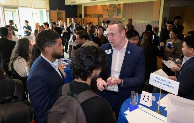 Two students talking to an employer at the AGSM Graduate Talent Forum 2025