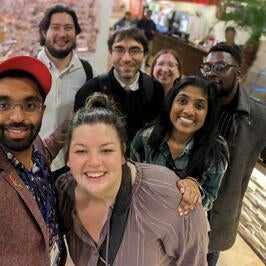 Fellows smiling together after karaoke 