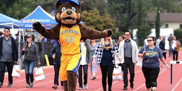 Scotty walks in front of staff and students at UC Walks event.