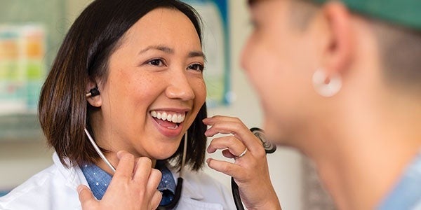 SHS Doctor talks with student during appointment.
