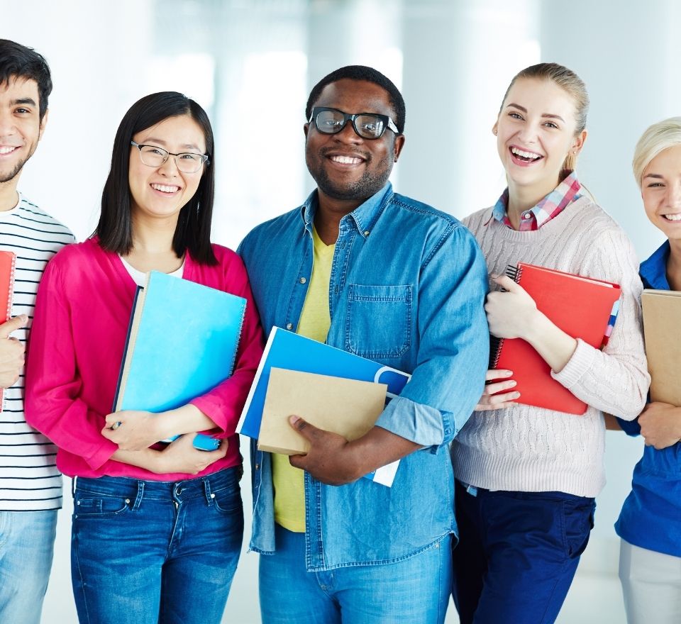 Group of diverse college students holding notebooks