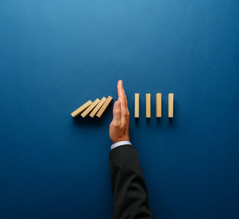 Hand separating wooden blocks in half to show a management role