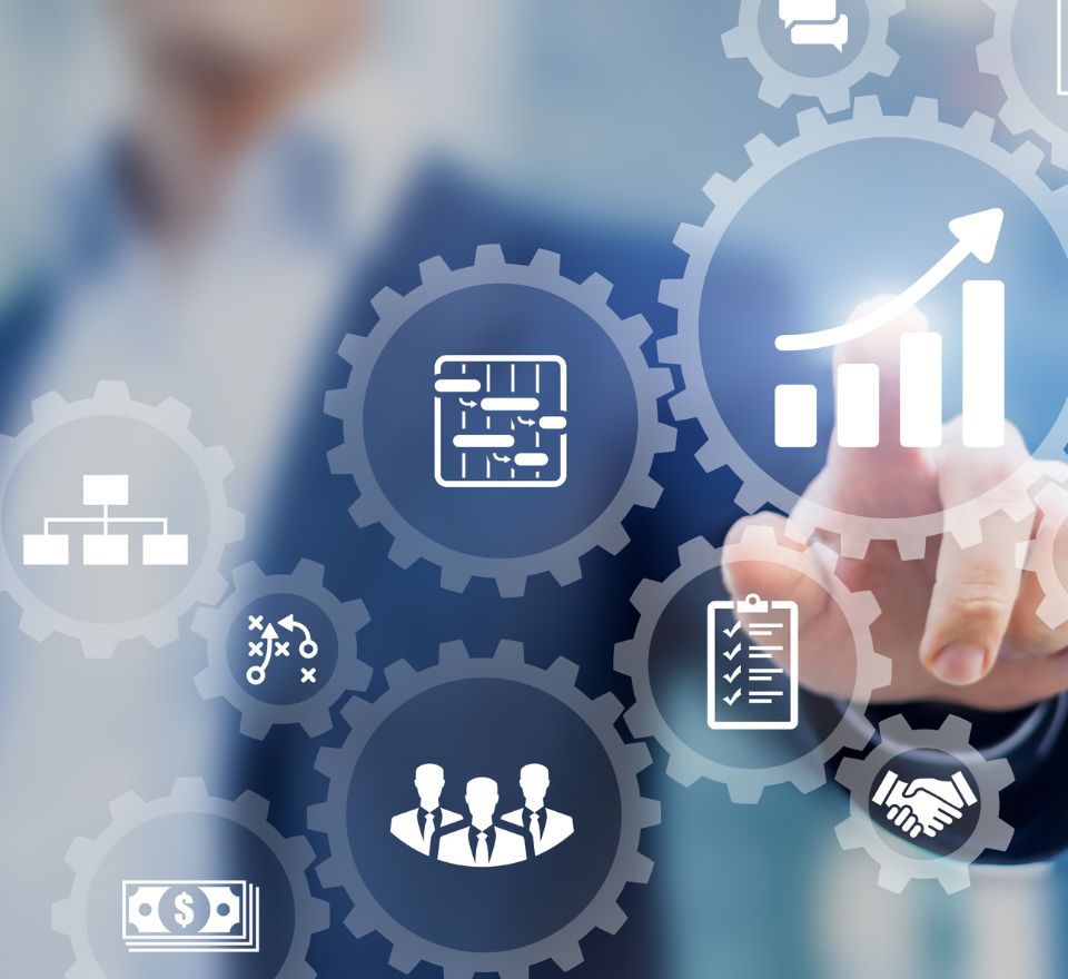 Hand pointing finger at gears with various project management icons