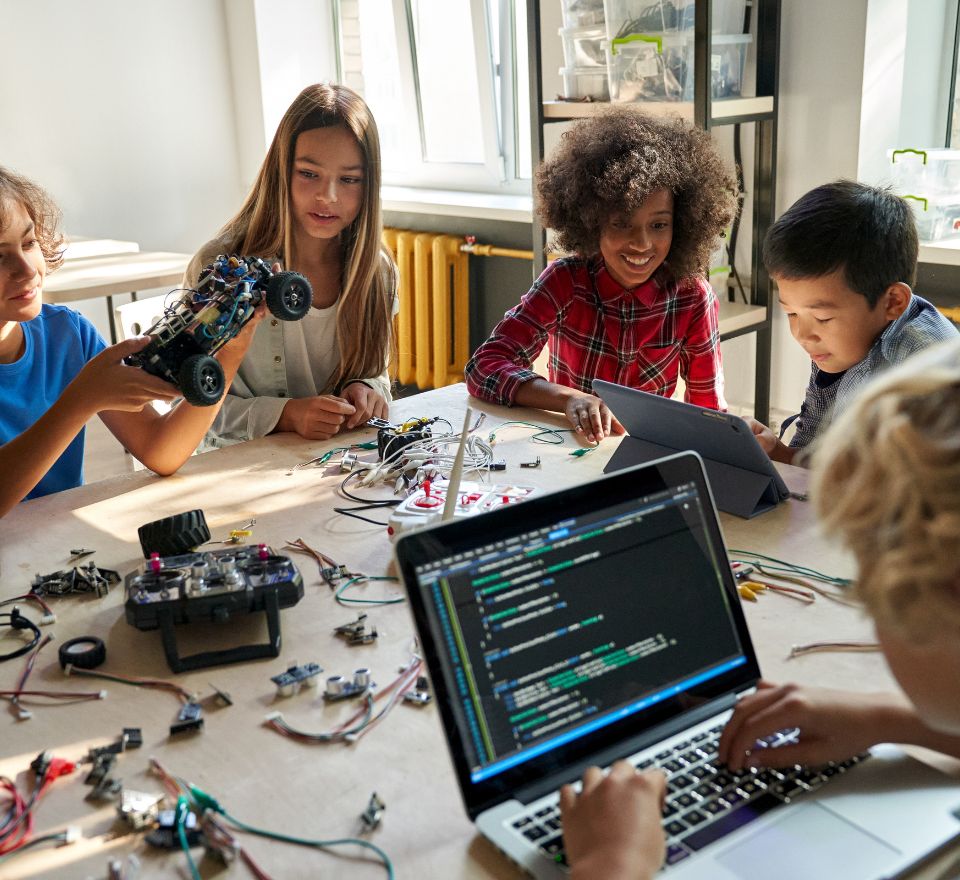 Elementary kids working together at a table on STEAM activities