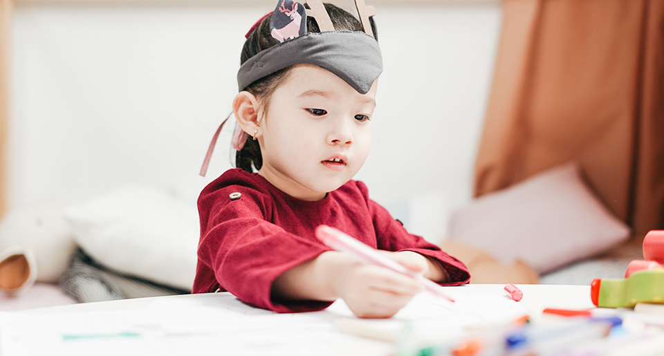Preschool Asian girl drawing