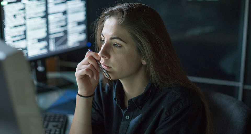 Close-up of the face of a young White women viewing her monitor